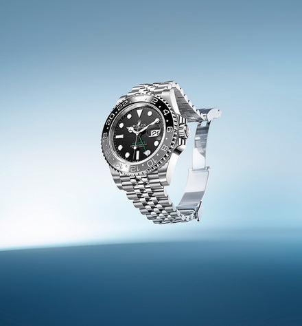 A stainless steel luxury wristwatch with a black dial, floating against a blue gradient background.