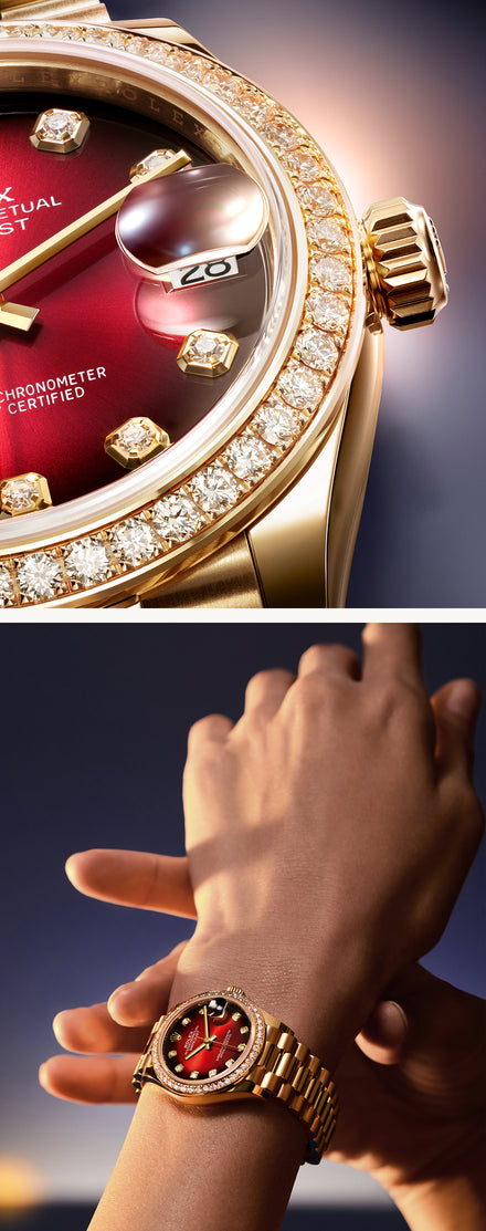 Close-up of a gold, diamond-studded watch with a red face, worn on a persons wrist.