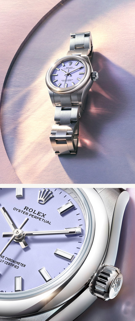 A silver Rolex Oyster Perpetual watch with a lavender dial on a metallic surface, shown close-up.