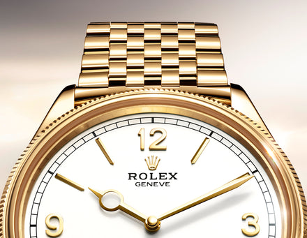 Close-up of a gold Rolex wristwatch with a white face and gold hour markers on a gold bracelet.