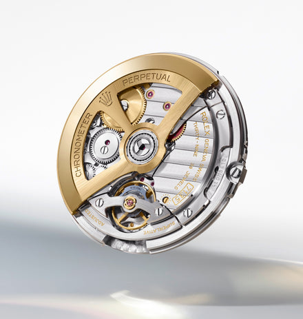 Close-up of a Rolex watch movement with gold and silver components, gears, and engraved text.