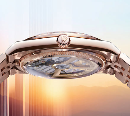 Side view of a luxury watch with a visible mechanical movement, set against a sunrise background.
