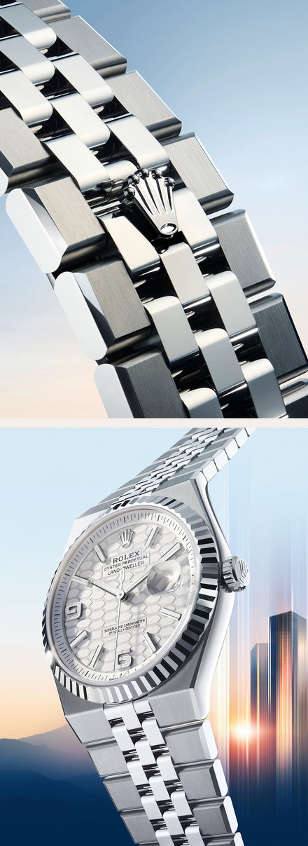 Close-up of a silver Rolex watch and bracelet against a blurred city skyline background.