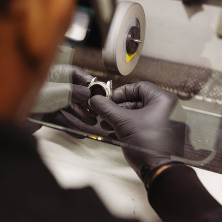 Watch maker polishing a case