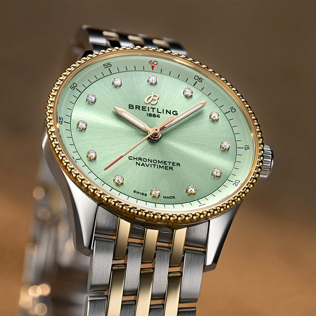 Breitling Navitimer 32mm watch with mint green dial, diamond hour markers, stainless steel and yellow gold case and bracelet.