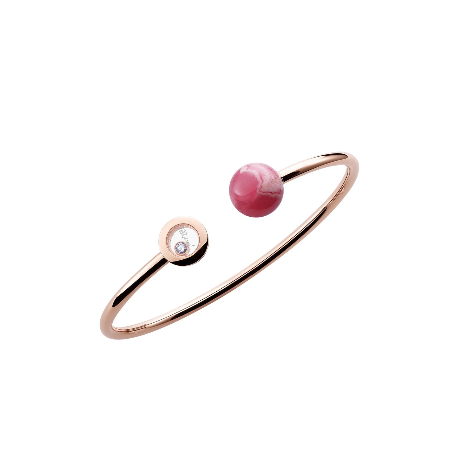 The Chopard Happy Diamonds Planet is a minimalist open bangle in rose gold, featuring a pink stone on one end and a round setting with dancing diamonds on the other.