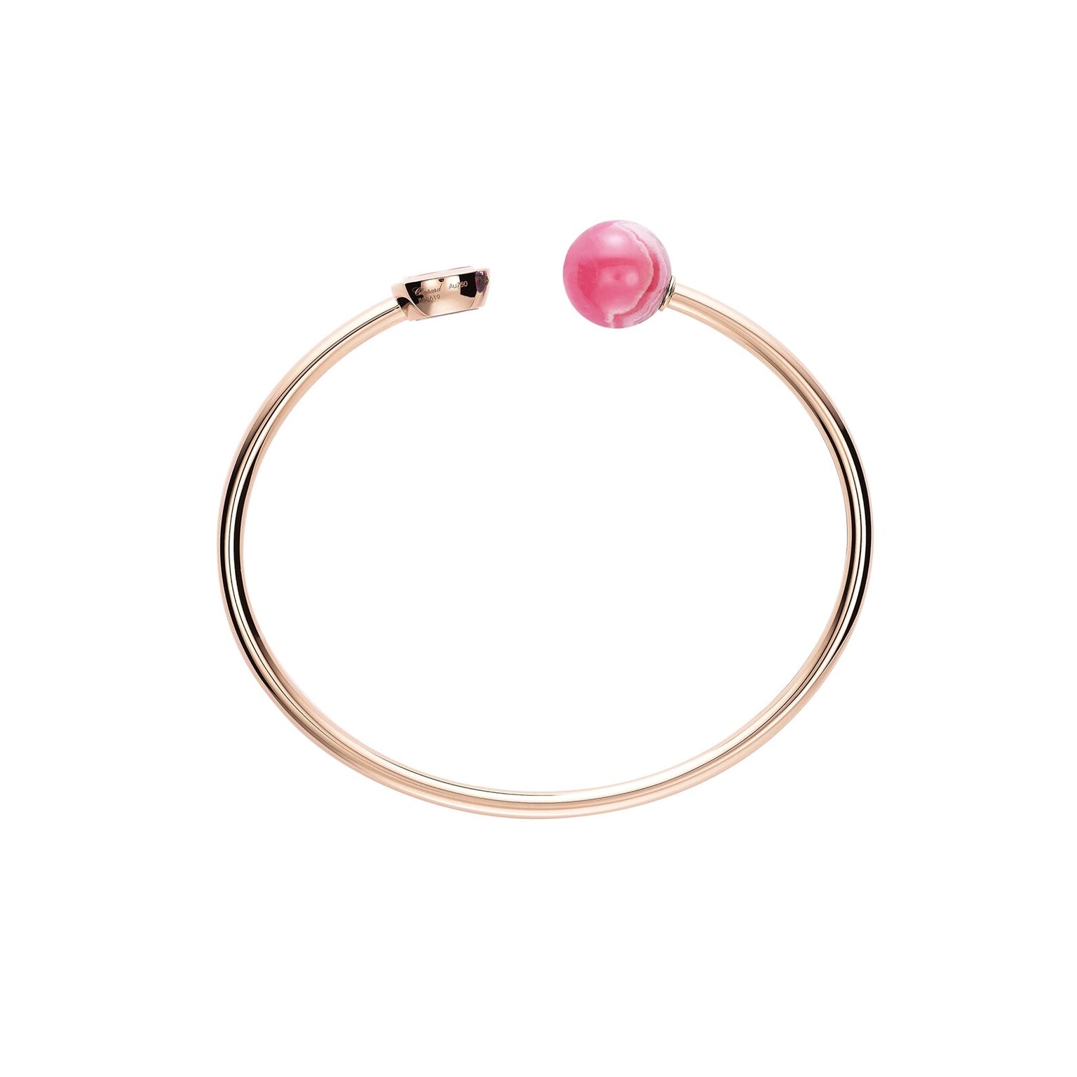 The Chopard Happy Diamonds Planet gold open-ended bracelet features a pink sphere inspired by Happy Diamonds jewelry, accented with a small gold cap at the other end, shown on a white background.