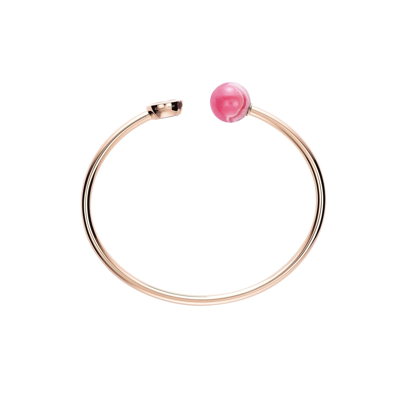The Chopard Happy Diamonds Planet gold open-ended bracelet features a pink sphere inspired by Happy Diamonds jewelry, accented with a small gold cap at the other end, shown on a white background.