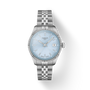 Silver Tissot watch with light blue dial on a white background