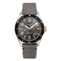 The Glashütte Original SeaQ Panorama Date features a gray dial with gold accents, black bezel, bold white numerals, date window at 4 o’clock, and a robust black cordura-effect rubber strap.