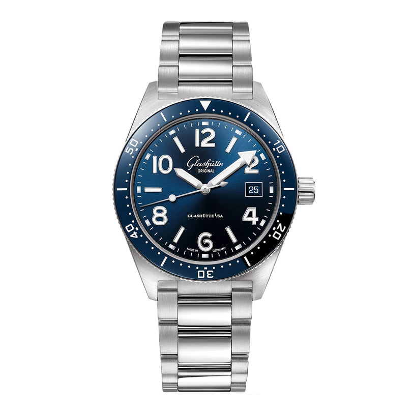 The Glashütte Original SeaQ features a silver case, blue bezel and dial with white numerals, a date display at 3 o’clock, and a metal link bracelet that elegantly reveals its mechanical movement.