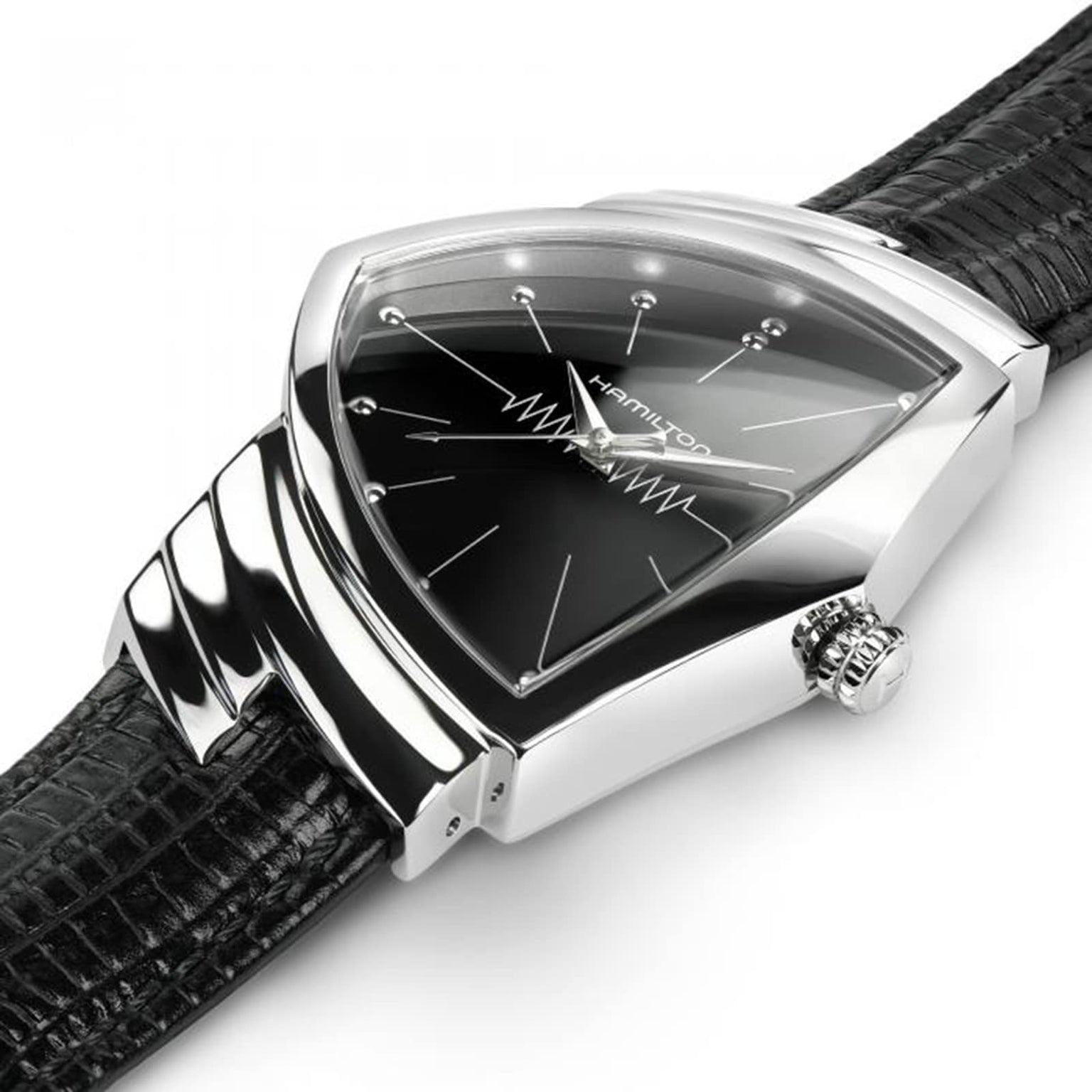 A close-up of the Hamilton Ventura Quartz wristwatch, featuring a triangular black dial, silver case, and black textured leather strap that highlights its iconic Mid-Century Modern design.