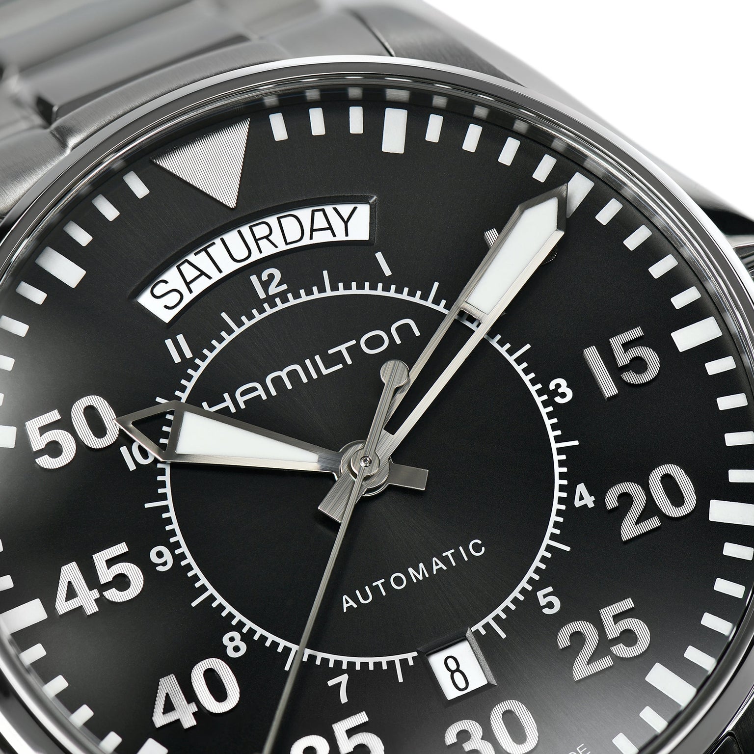 Close-up of a Hamilton Khaki Aviation Pilot Day Date Auto wristwatch with automatic movement, day display set to Saturday, Arabic numerals on the dial, and the time shown at about 10:08:36.