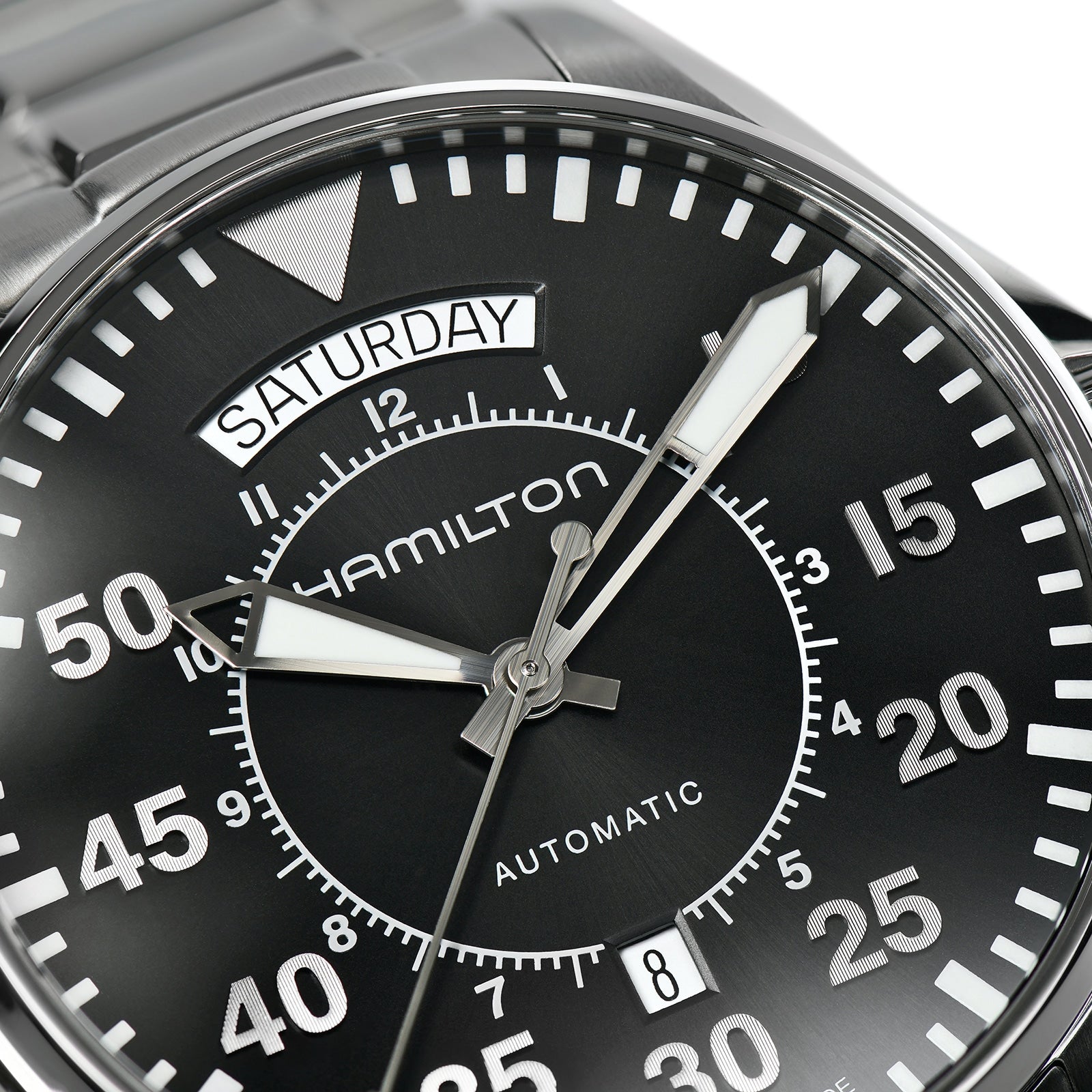Close-up of a Hamilton Khaki Aviation Pilot Day Date Auto wristwatch with automatic movement, day display set to Saturday, Arabic numerals on the dial, and the time shown at about 10:08:36.