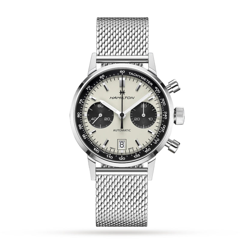 The Hamilton American Classic Intra-Matic Auto Chrono features a silver stainless steel mesh bracelet, cream and black panda dial, two subdials, a date window at 6 o’clock, and a tachymeter scale.