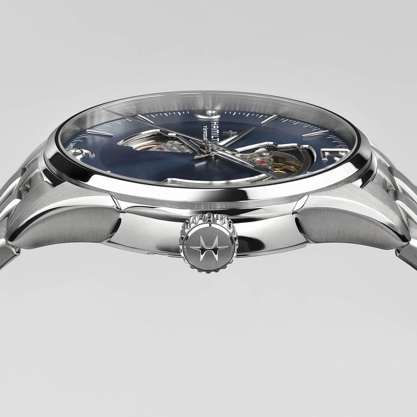 A close-up side view of the Hamilton Jazzmaster Open Heart Auto wristwatch features a blue open-heart dial, the Hamilton logo on the crown, and highlights its precise Swiss automatic movement.
