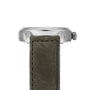 Side view of the Hamilton Khaki Field Titanium Auto watch case in silver with a textured green strap and visible crown, set against a white background.