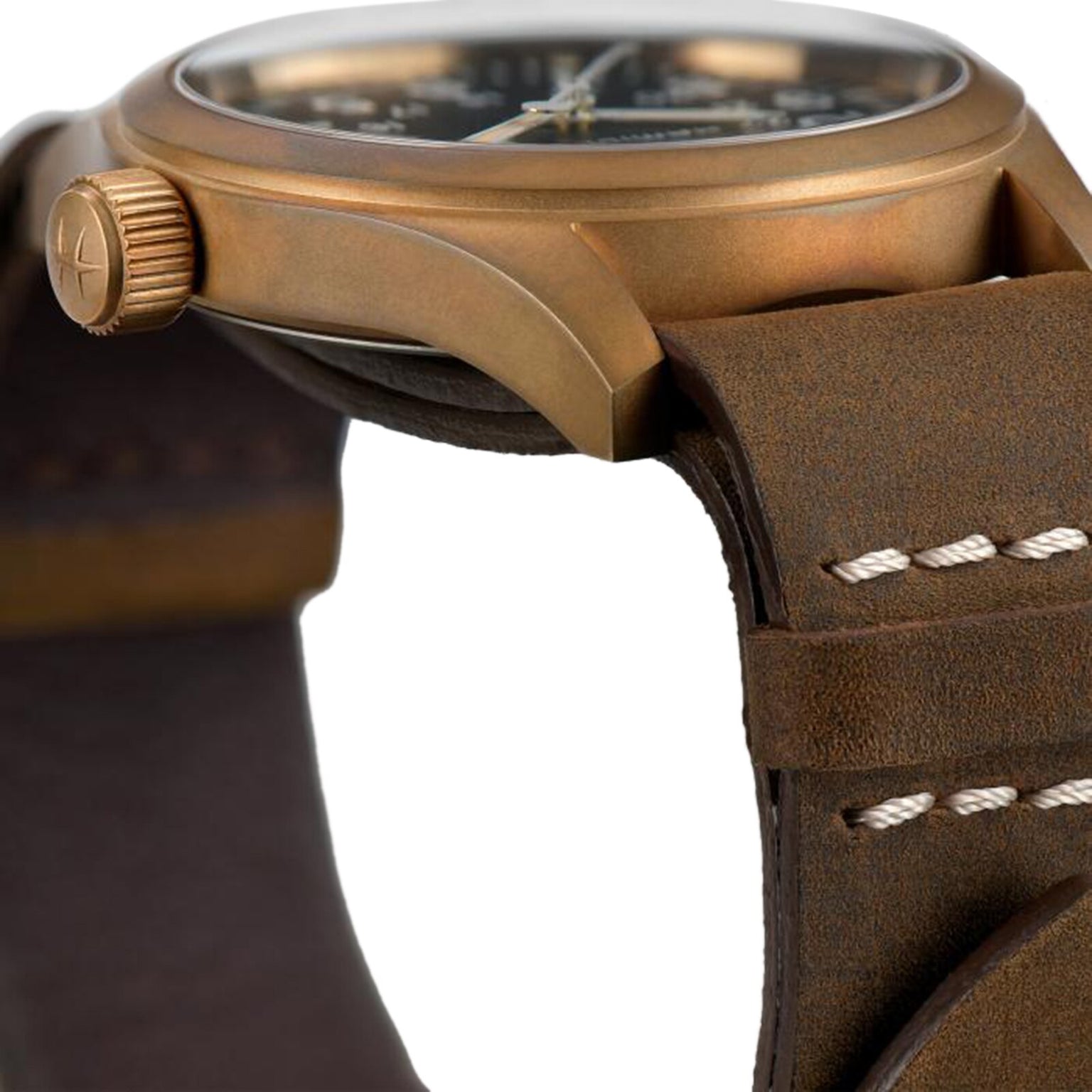 Close-up of the Hamilton Khaki Field Mechanical watch with a bronze case, textured crown, and brown leather strap with white stitching, highlighting its military heritage.