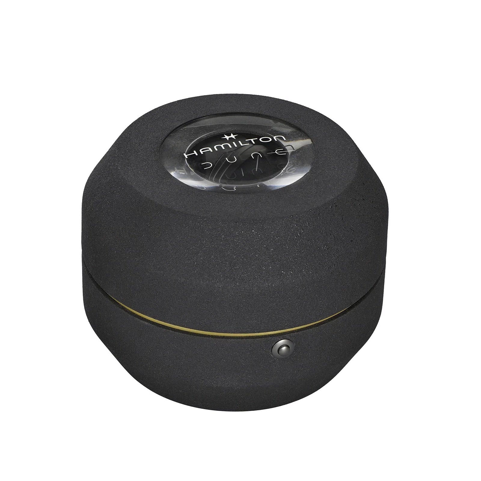 A black, round Hamilton watch case with a glass top featuring the Hamilton logo, created as commemorative packaging for the Ventura XXL Bright Dune Limited Edition.