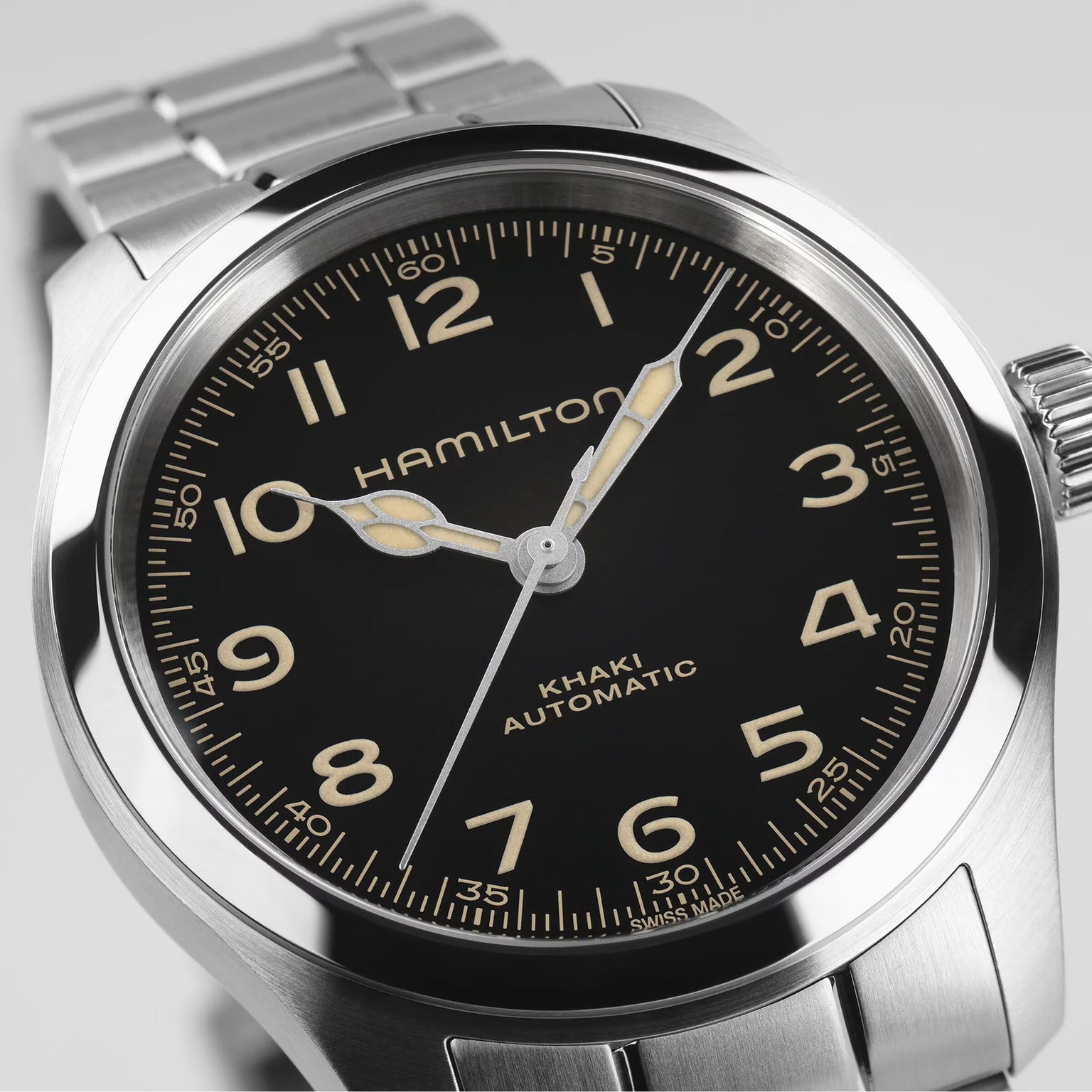 Close-up of the Hamilton Khaki Field Murph 38mm, featuring a black dial, luminous hands, Arabic numerals, and a stainless steel bracelet—a modern interpretation of this classic timepiece.