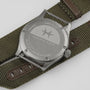 Back of a Hamilton Khaki Field Quartz watch featuring an olive green fabric strap and engraved star logo on the case back.