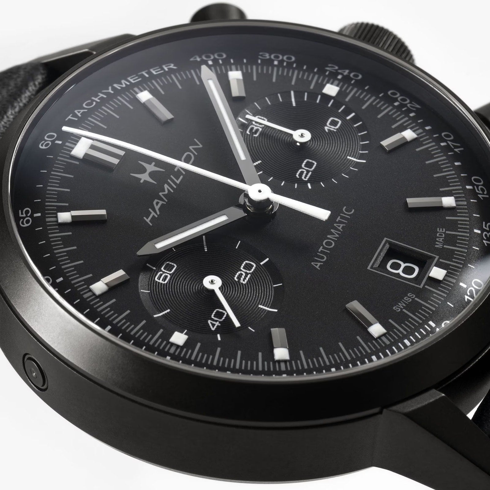 Close-up of a Hamilton American Classic Intra-Matic Auto Chrono, a black automatic chronograph watch featuring a date display set to the 8th.