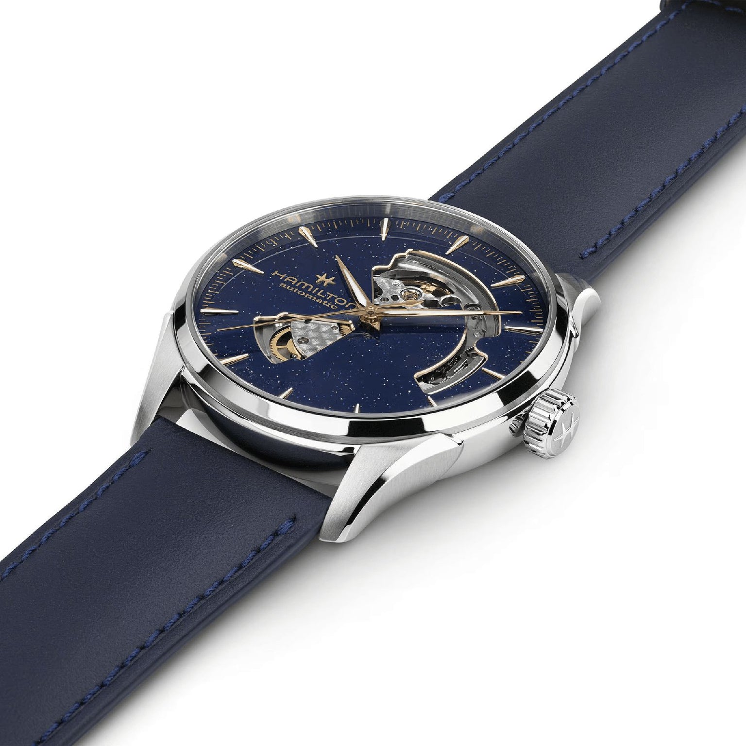 A close-up of the Hamilton Jazzmaster Open Heart Auto 42mm dress watch featuring a navy blue leather strap, silver case, and partially open-worked blue dial that reveals its automatic movement.