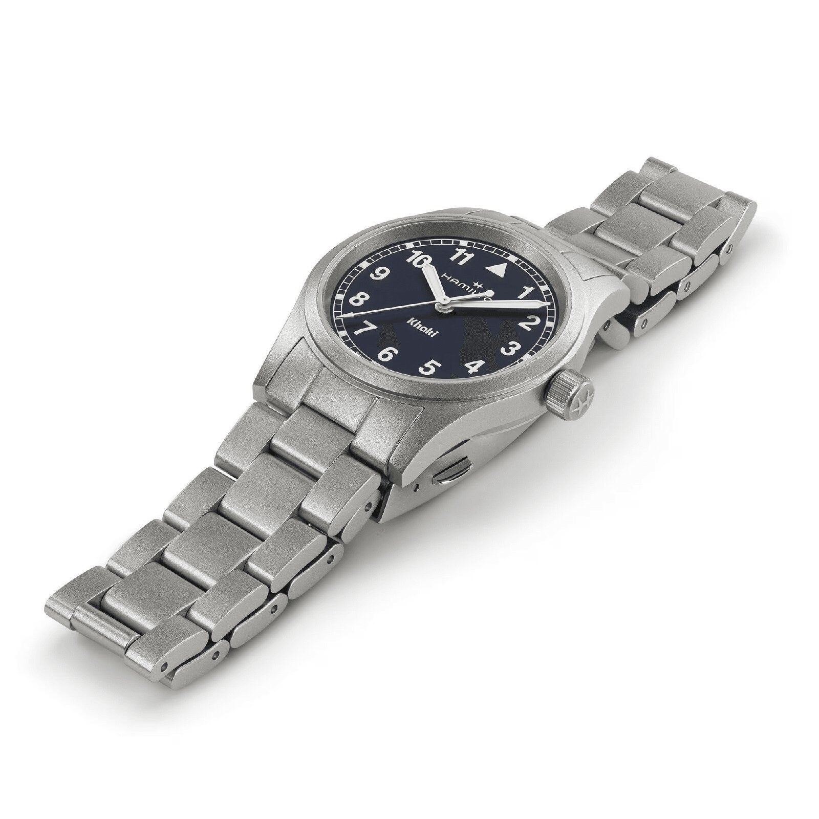 The Hamilton Khaki Field Quartz 33mm is a silver metal wristwatch with a linked band, black dial, and white Arabic numerals, showcased on a white background.