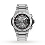 The Hublot Big Bang Integrated Titanium is a self-winding chronograph wristwatch, featuring a skeleton dial with visible gears and a titanium bracelet, shown on a white background.