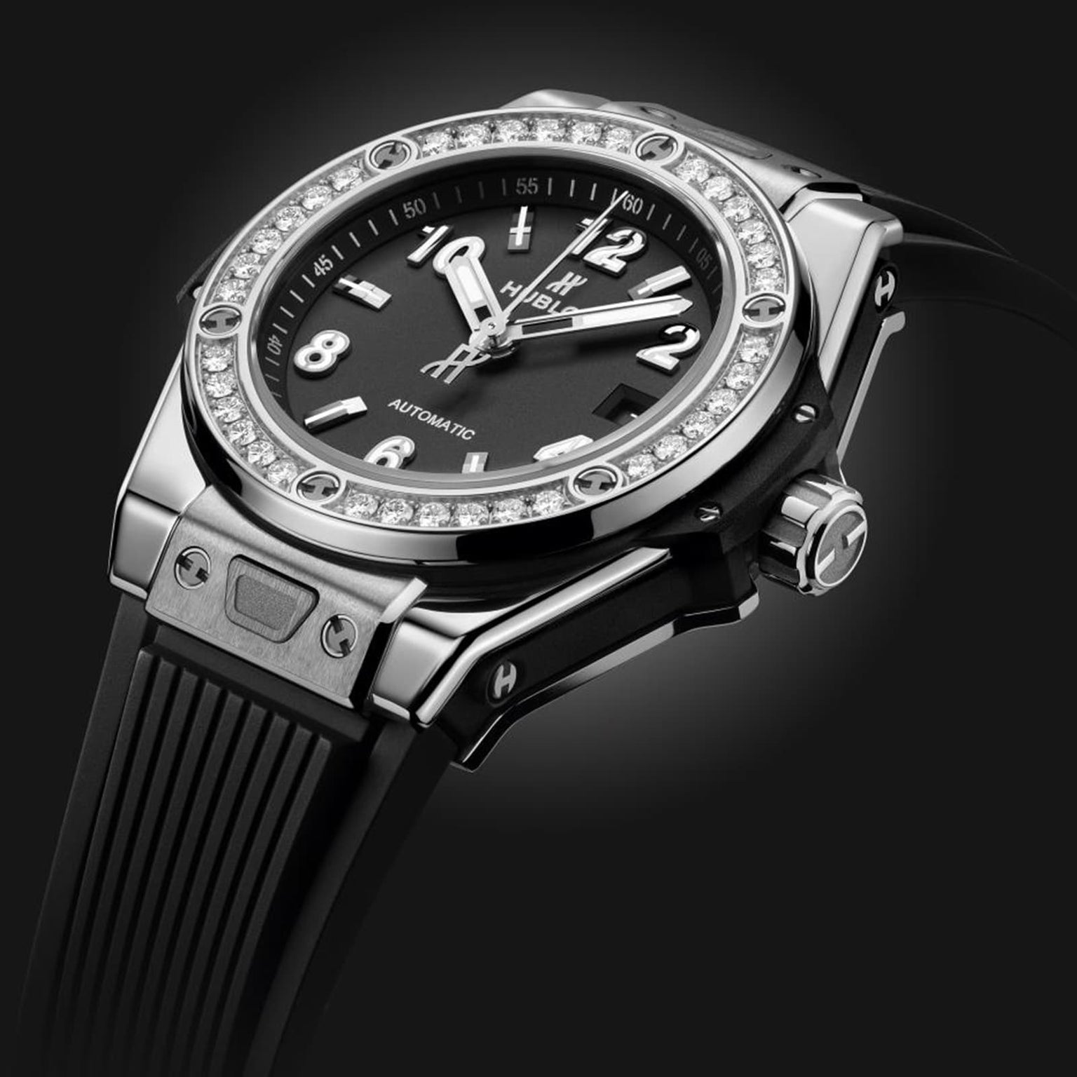 A close-up of the Hublot Big Bang One Click Steel Diamonds wristwatch featuring a black dial, diamond bezel, stainless steel case, rubber strap, and silver hour markers.