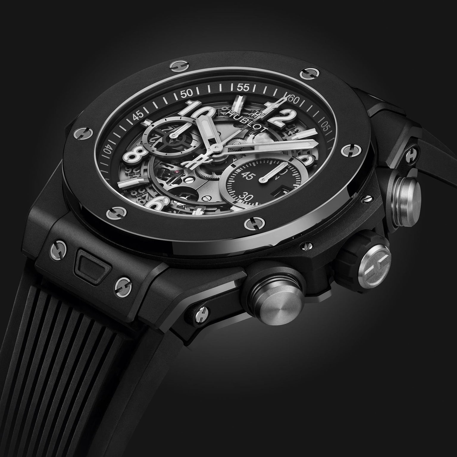 Close-up of the Hublot Big Bang Unico Black Magic, showcasing its UNICO movement, skeleton dial with visible mechanics, and textured side buttons—all highlighted against a dark background.