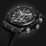 Close-up of the Hublot Big Bang Unico Black Magic, showcasing its UNICO movement, skeleton dial with visible mechanics, and textured side buttons—all highlighted against a dark background.