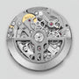 The Hublot Spirit Of Big Bang Magic Sapphire features a circular mechanical movement with visible gears and intricate metal details, all showcased beneath durable sapphire crystal on a brushed metal finish case against a plain background.