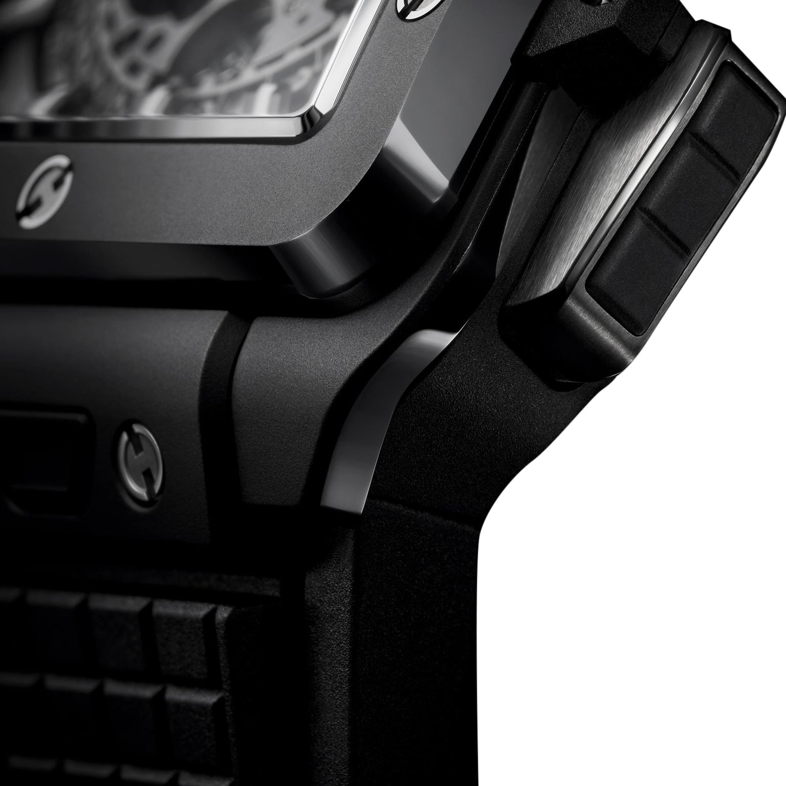 Close-up of the Hublot Square Bang Unico Black Magic wristwatch, showing its case, crown, and textured strap with a sapphire crystal skeleton dial in the signature Square Bang design—set against a white backdrop.