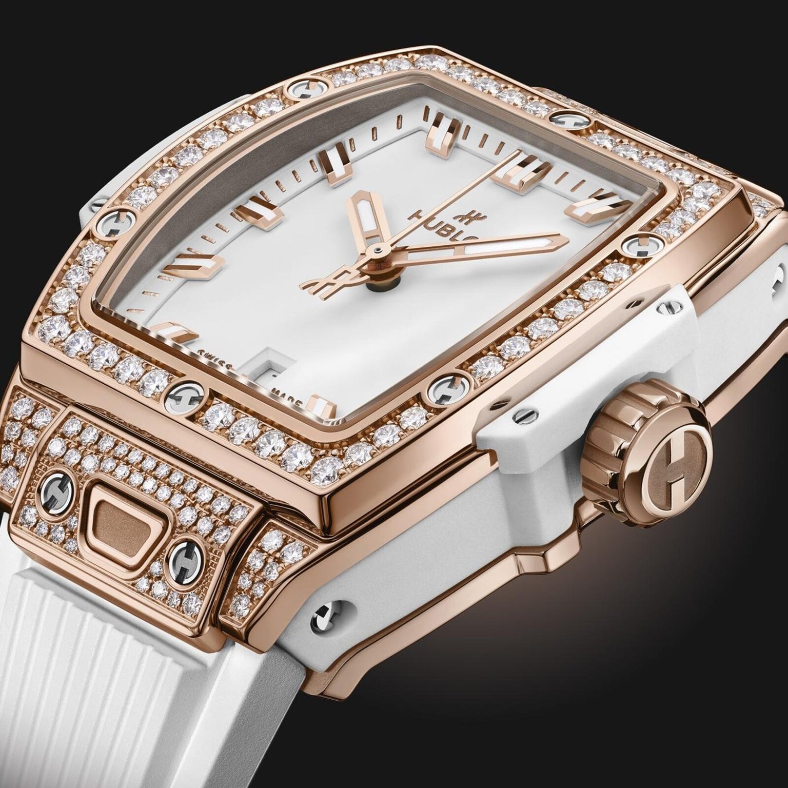 Close-up of the Hublot Spirit Of Big Bang King Gold White Pavé wristwatch, featuring a white and King Gold case, diamond-set bezel, white strap, and three gold hands on a minimalist dial.