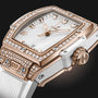 Close-up of the Hublot Spirit Of Big Bang King Gold White Pavé wristwatch, featuring a white and King Gold case, diamond-set bezel, white strap, and three gold hands on a minimalist dial.