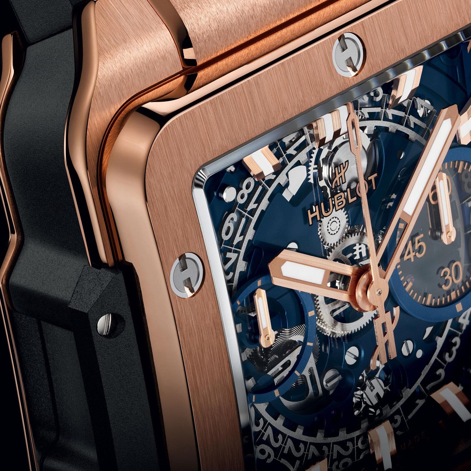 Close-up of Hublots Square Bang Unico King Gold Blue, showcasing its 18k King Gold case, blue dial, and exposed gears that highlight the timepiece’s intricate craftsmanship and mechanical details.