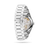 The Girard-Perregaux Laureato 42 is a silver metal wristwatch with an octagonal bezel and an exhibition case back that showcases its mechanical movement and internal gears.