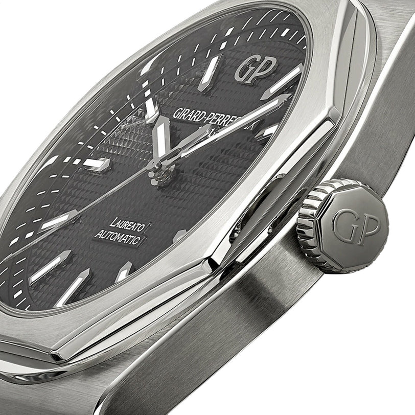 Close-up of a Girard-Perregaux Laureato 42 watch with an octagonal bezel, textured black dial, silver hands and markers, and a crown engraved with the GP logo.