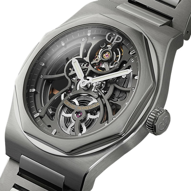 A close-up of the Girard-Perregaux Laureato Skeleton showcases visible gears, intricate mechanics, an octagonal bezel, stainless steel case and bracelet, plus the GP logo on the crown.