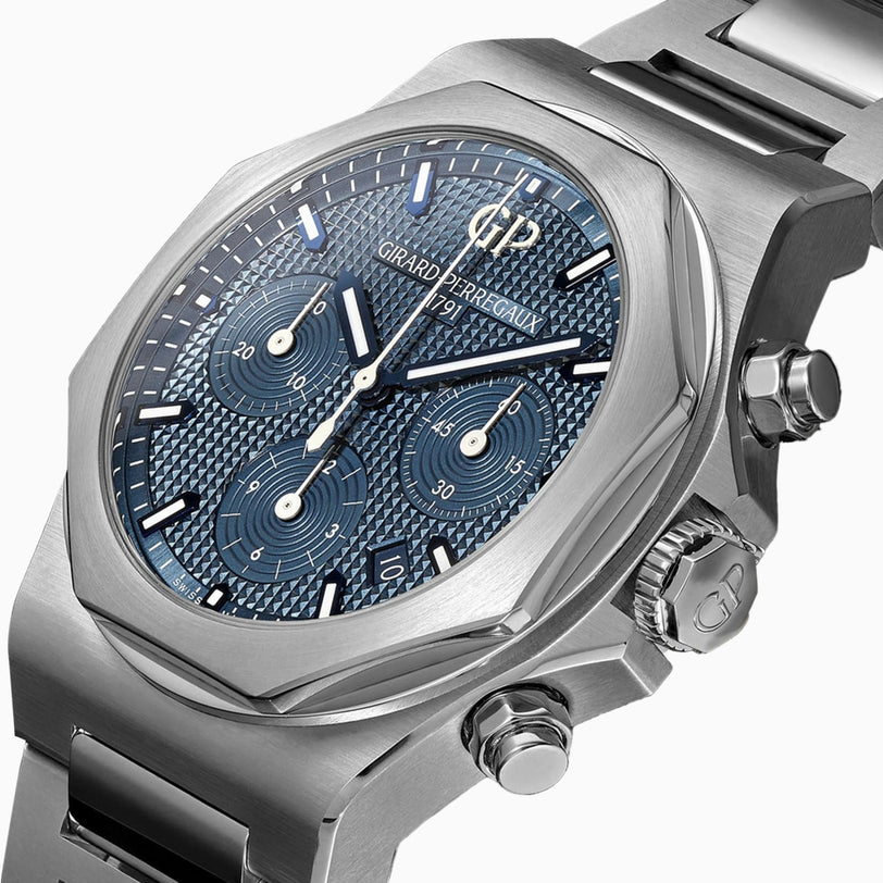A close-up of the Girard-Perregaux Laureato Chronograph 42 showcases its textured blue dial, octagonal bezel, three subdials, silver hour markers, and durable 904L steel case.