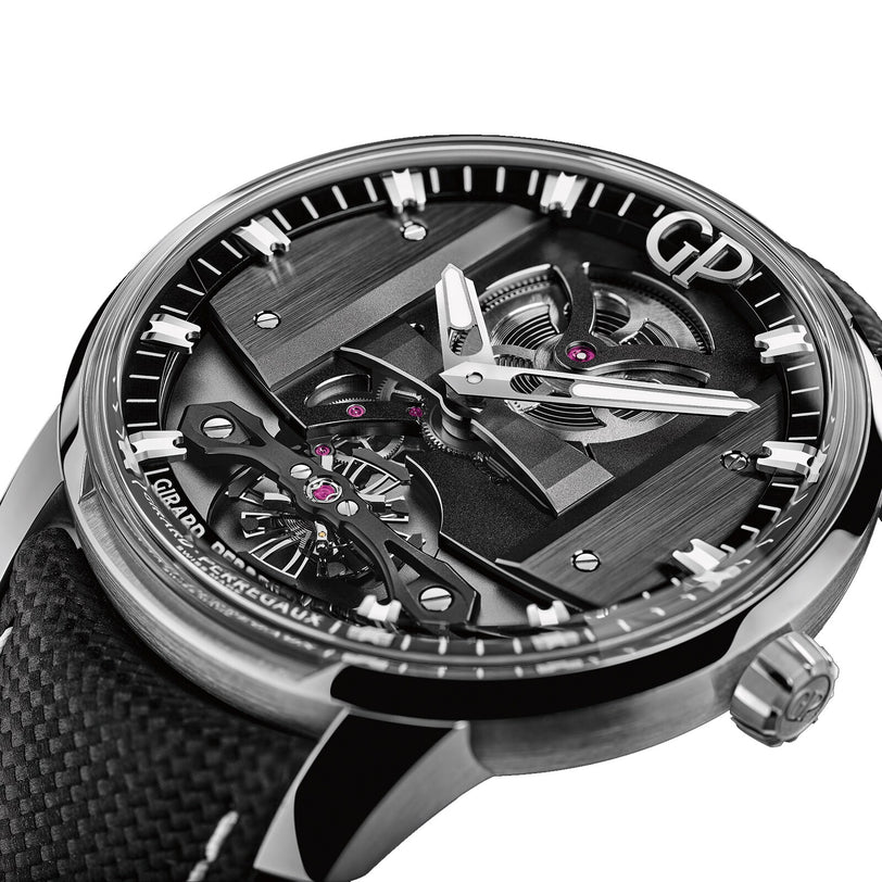 Close-up of the Girard-Perregaux Free Bridge wristwatch, showcasing a black open-worked dial with visible automatic movement and GP initials, paired with a textured black strap.