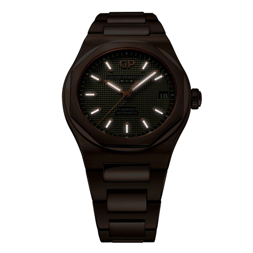 The Girard-Perregaux Laureato 42, a dark metal wristwatch with a round face, luminous hour markers, date at 3 o’clock, and link bracelet, is shown on a white background.