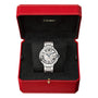 A Ballon Bleu de Cartier wristwatch by Cartier with a silver metal band, steel case, and Roman numeral face is shown in an open red Cartier box with a black interior; it features a self-winding mechanical movement.