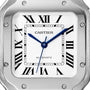 Close-up of the Cartier Santos de Cartier watch face, featuring Roman numerals, blue hands, and a brushed square steel case. The time at about 10:10:37 is powered by the calibre 1847 MC movement.