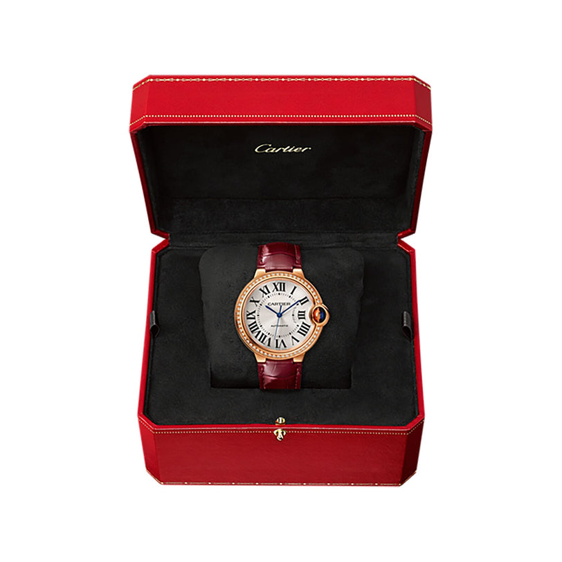 A Ballon Bleu de Cartier wristwatch by Cartier with a leather strap, presented in a red Cartier box with black interior.