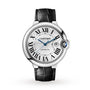 The Ballon Bleu de Cartier by Cartier features a silver round face, black Roman numerals, blue hands, date window, and black leather strap—showcasing timeless elegance against a white background.