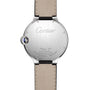 Back view of the Ballon Bleu de Cartier by Cartier, highlighting engraved details, a stainless steel case, beige leather strap, and the brand’s signature blue cabochon crown.