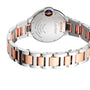 A close-up of the Ballon Bleu de Cartier watch by Cartier, showcasing its two-tone silver and rose gold metal bracelet and the engraved details on its case back.