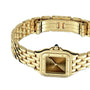 The Panthère de Cartier Small Model by Cartier showcases a yellow gold link bracelet, square face, and a small blue sapphire on the crown, displayed against a white background.